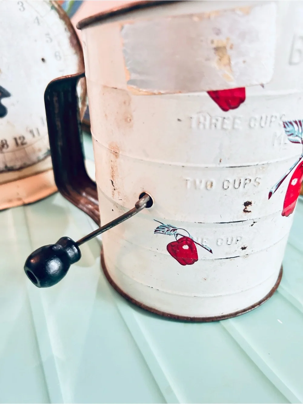 Vintage flour sifter with apple motif